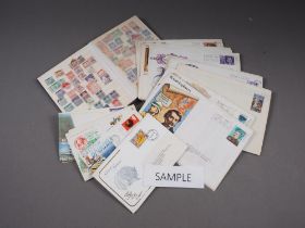 A quantity of ephemera, including a cigarette card album, two stamp albums, first day covers and a