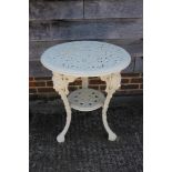 A 19th cast iron two-tier pub table with pierced top and mask supports, 24" dia