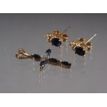 A pair of yellow metal sapphire and diamond ear studs, and a matching cross