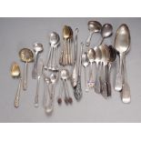 A selection of silver flatware, including teaspoons, a sifter spoon, a tablespoon, two caddy spoons,