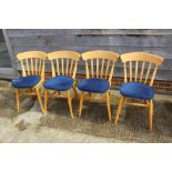 A set of four Windsor lath back chairs with loose seat squabs