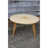 A 1950s light oak circular top coffee table, on splay supports, 29" dia x 17" high and a white