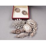 A pair of silver cufflinks, decorated horses heads, five Victorian and later silver brooches and a
