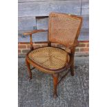 A 1930s walnut cane seat and back occasional chair, on cabriole stretchered supports