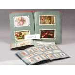 A quantity of 19th century and later ephemera, including postcard albums, cigarette card albums,