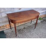 A 19th century mahogany "D" shape side table, on turned and castored supports, 46" wide x 22" deep x