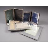 A silver hinged double photograph frame, a rectangular silver photograph frame and four silver