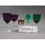 A set of six amethyst coloured wines, two other similar glasses, a uranium coloured glass and