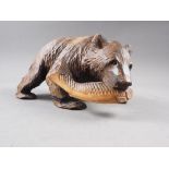 A carved model bear with a salmon, 9 1/2" x 5 1/2"