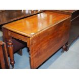 A late 19th century mahogany Pembroke dining table with deep leaves, on turned castored supports,