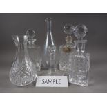 Three matching decanters and stoppers, four other decanters, two carafes, a pair of scent bottles