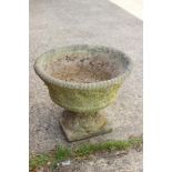 A pair of cast stone circular planters with lattice decoration, on square bases, 16" dia