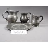 A Victorian pewter quart tankard, a pewter lidded jug, four pewter tankards and other pewter items