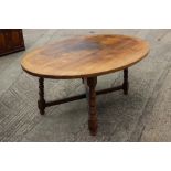 An oak oval top dining table, on turned splay supports, 72" wide x 48" deep x 29 1/2" high