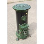 A Godin green and black enamel stove (gas fired), 14" dia x 30" high, on scroll feet