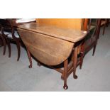 A provincial oak and drop leaf dining table, fitted drawer, on pole turned supports and