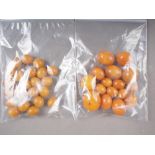 A number of loose butterscotch/egg yolk amber beads, the largest oval bead 16mm wide, and a number