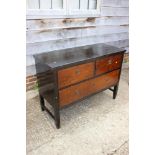 An early 20th century black jappaned hardwood chest of two short and one long drawer, on square