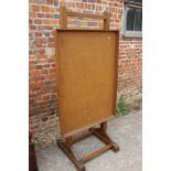 A freestanding oak and cork faced adjustable bulletin board, 31" wide x 23" deep x 68" high