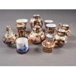 A group of Royal Crown Derby bone china Imari decorated miniature items, including a pair of two-