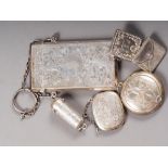 A silver card case with engraved scrolled decoration, a silver cheroot holder, two stamp holders and