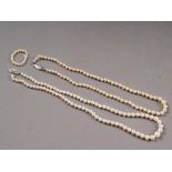 A graduated cultured pearl necklace with 14ct white gold, pearl and diamond clasp, and another