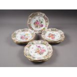 A set of twelve Dresden porcelain cabinet plates with pierced borders and hand painted floral