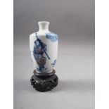 A Chinese blue and white and iron red porcelain miniature vase, decorated single figure, four-