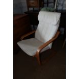 A beech framed cantilever armchair, upholstered in an off-white linen fabric