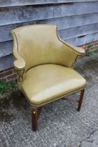 A studded armchair, upholstered in a mustard leather, on stained as walnut cross stretchered