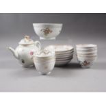 An 18th century Worcester teapot with floral spray decoration, similar tea bowls, saucers and a