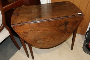 A provincial mahogany oval drop leaf table, on six square taper supports, 35" wide x 50" deep x