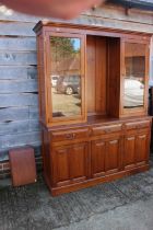 A cherrywood side cabinet, fitted two glazed compartments, central recess over three drawers and