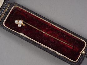 A yellow metal, seed pearl and diamond stick pin