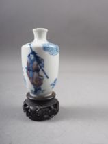 A Chinese blue and white and iron red porcelain miniature vase, decorated single figure, four-