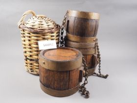 Three coopered oak barrels with chains, in graduated sizes, tallest 8 1/4" high, a canework