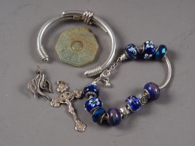 A silver modernist brooch, a white metal Corpus Christie pendant, a silver cuff bracelet, a white