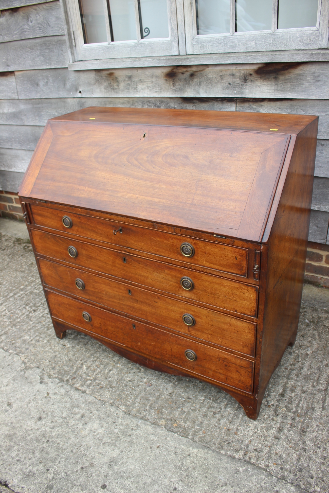 A Georgian mahogany fall front bureau, the interior fitted pigeonholes and drawers over four long