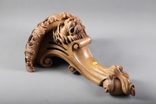 A carved wall bracket, formed as a lion's head with scrolls and talon, 18 1/4" high x 15" wide