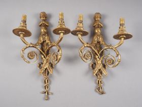 A pair of cast brass floral and scrolled two-light wall sconces with putti and trumpet finial 15”