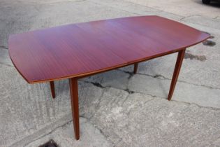 A 1960s sapele mahogany oval extending dining table, by Vanson, with one extra leaf, on moulded