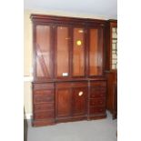 A late Victorian mahogany bookcase enclosed four glazed doors over ten side drawers and centre