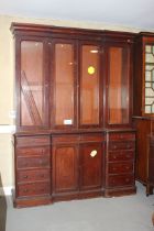 A late Victorian mahogany bookcase enclosed four glazed doors over ten side drawers and centre