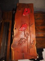 A carved yew wood plaque with relief poppy design, 49" x 20 3/4"