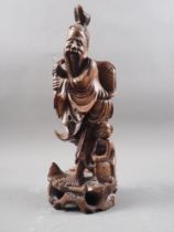 A Chinese carved hardwood figure of a sage and acolyte, 12" high, on ebonised stand