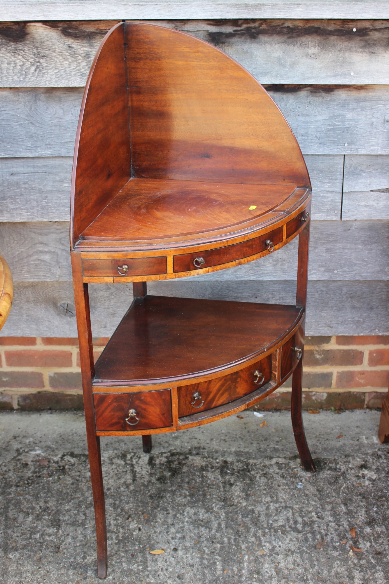 A 19th century mahogany bowfront corner washstand, fitted two drawers, on splay supports, 24" wide x