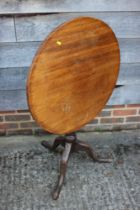 An early 19th century mahogany circular tilt top occasional table, on turned column and tripod splay