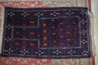 A Bokhara prayer rug with numerous guls on a dark blue ground, 50" x 30" approx