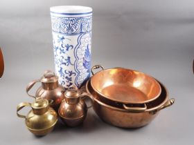 A copper Jersey jug, 8 3/4" high, another smaller, a brass jug, two copper two-handled bowls, and