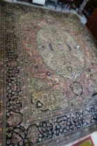 A Persian Kerman city carpet with all-over foliate design and central medallion on a cream ground